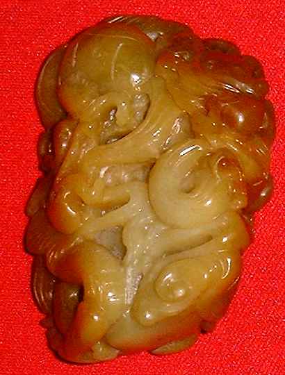 Orange-red coloured jade piece